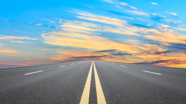 istock Asphalt road and sunset sky 1154979215