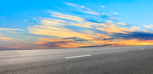 istock Asphalt road and sunset sky 1154980071