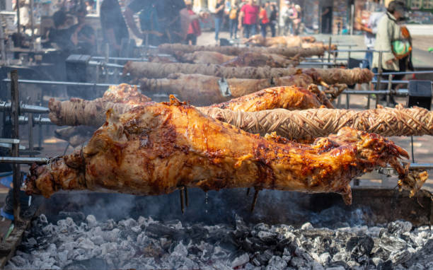istock Greek Easter custom. Kokoretsi, kokorec and lamb, sheep, kid grilling on spits over charcoals fire. 1154980169