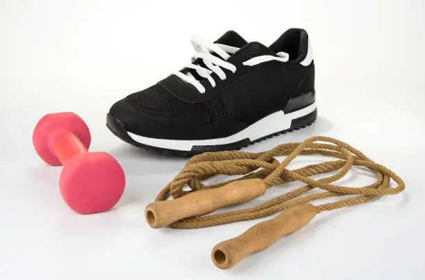 Skipping rope with sport shoe and dumbbell. Healthy lifestyle concept