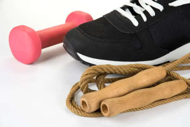 Skipping rope with sport shoe and dumbbell. Healthy lifestyle concept