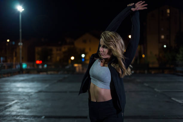 istock Young woman is preparing for late night training 1154981845