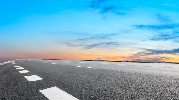 istock Asphalt road and sunset sky 1154982239