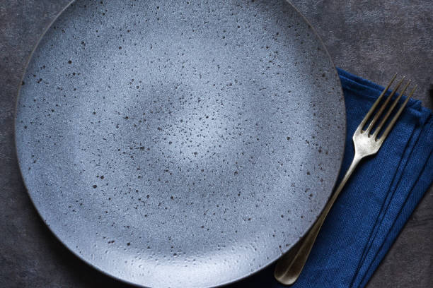 istock Empty dark plate and napkin with space for text. View from above. 1154982262