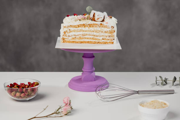 istock Confectioner's table. Cut white puff cake and pastry tools. 1154983738