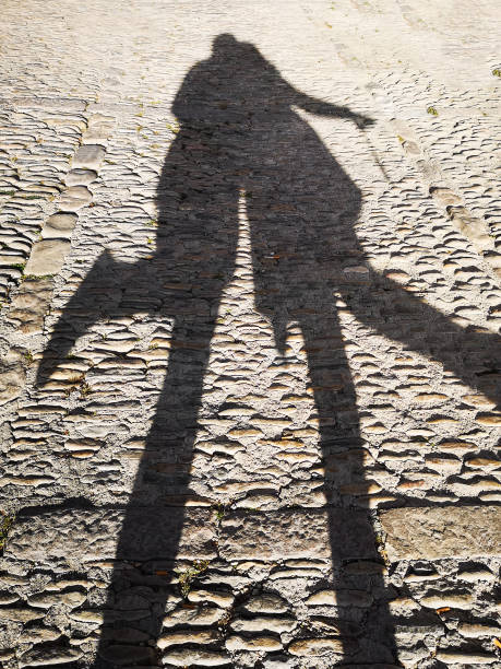 istock shadow of two people jumping 1154985904