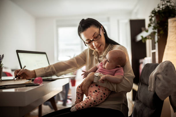 istock Young mother working and spending time with baby 1154986940