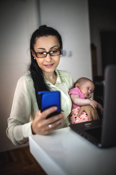 istock Young mother working and spending time with baby 1154987404