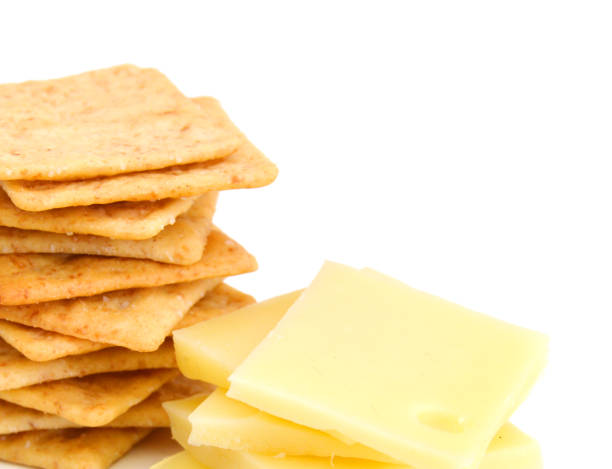 istock Delicious crackers with cheese on white background 1154990661