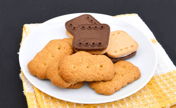 istock Freshly baked chocolate chip cookies in plate on black background 1154990683