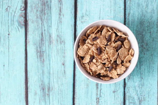 istock top view of cereals in a white bowl on blue background 1154993816