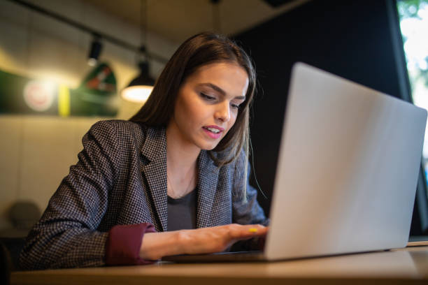 istock Gorgeous businesswoman typing a work email to her workers 1154994082