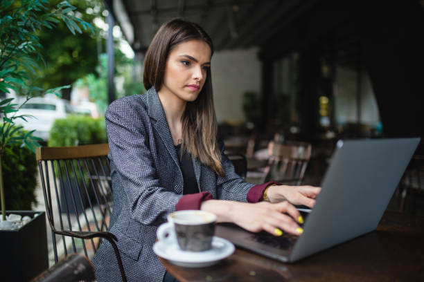 istock Focused businesswoman working while having some coffee 1154994634