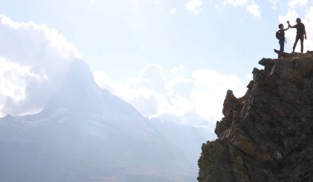 They high-five after finishing the climb
