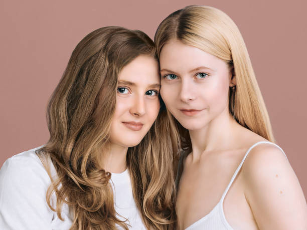 Two best friends Close-up portrait Long haired blonde and brunette are standing next to each other dearness stock pictures, royalty-free photos & images