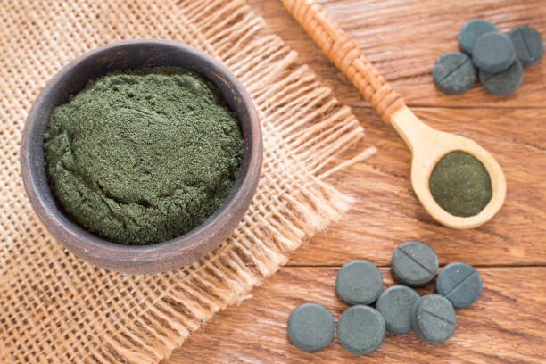 istock Spirulina algae powder and tablets. Arthrospira platensis 1154998844