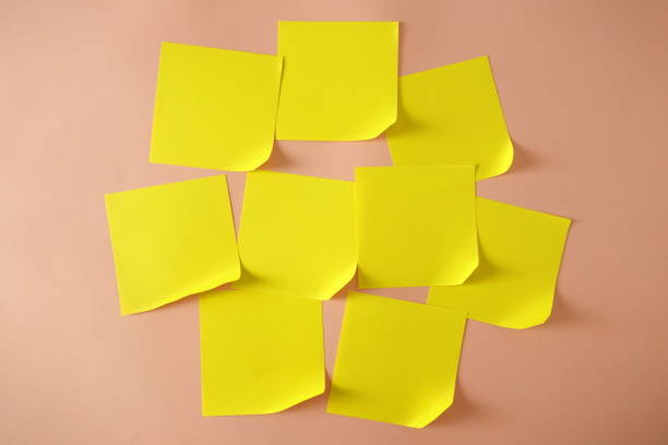 istock Yellow sticky notes with curled corner on pink background, copy space for design 1154999938