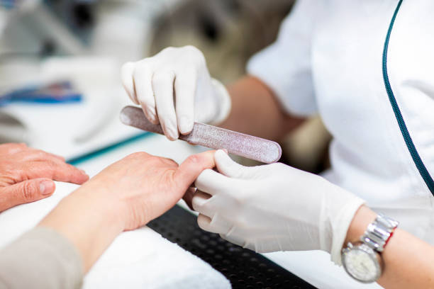 istock Using a nail file to do manicure in a cosmetic center 1155000117