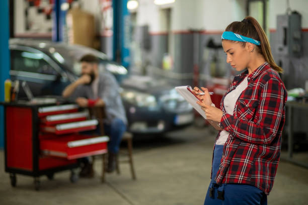istock Two car mechanics servicing the car 1155002907