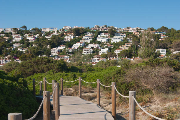 istock Panoramic view on white houses with beach path of Spanish island 1155004758