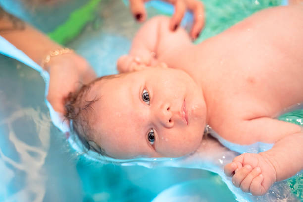 Baby boy swimming in pool