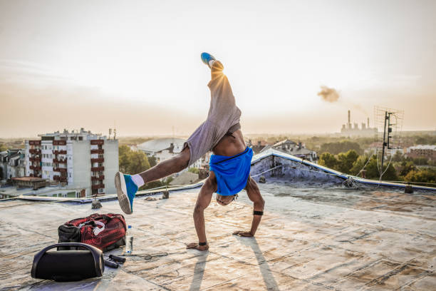 istock fit young man doing a handstand on the rooftop 1155015118