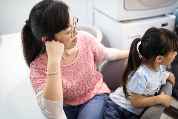 istock Single mother sitting in dining room with her daughter 1155016080