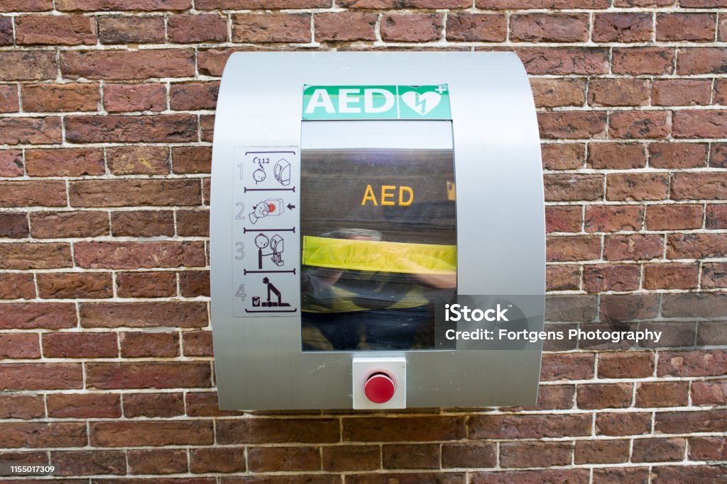 AED (Automated External Defibrillator) - Heart defibrillator in a public location for life-saving cardiopulmonary resuscitation. Defibrillator Stock Photo