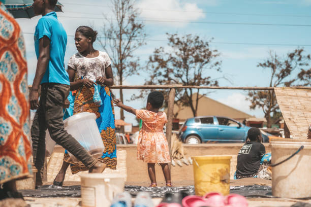 Mzuzu, Malawi - February 27, 2019: young african woman with little girl at the market in Mzuzu, Malawi