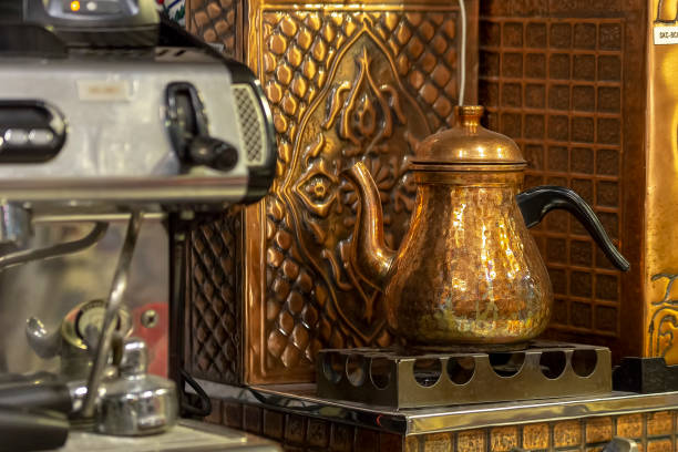 istock Turkish copper teapot. Drinking traditional Turkish Tea with kettle in cafe 1155018765