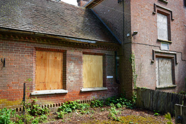 istock Old abandoned building with boarded up windows 1155020447