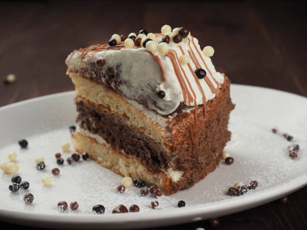 istock Delicious chocolate cake on plate on table on dark background 1155020792