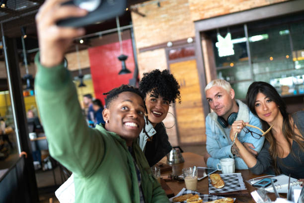 istock Group of friends taking a selfie in a cafeteria 1155021506