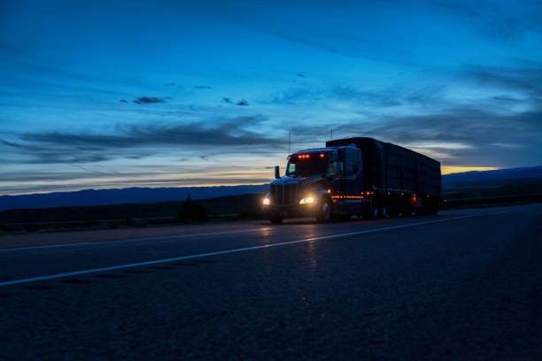 A Semi Trailer Truck Driving Down The Highway In Colorado At Night stock photo
