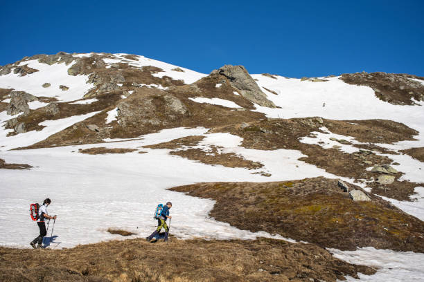 istock Two Hikers Walking on Snowy Mountain, Wilderness Area. 1155022890
