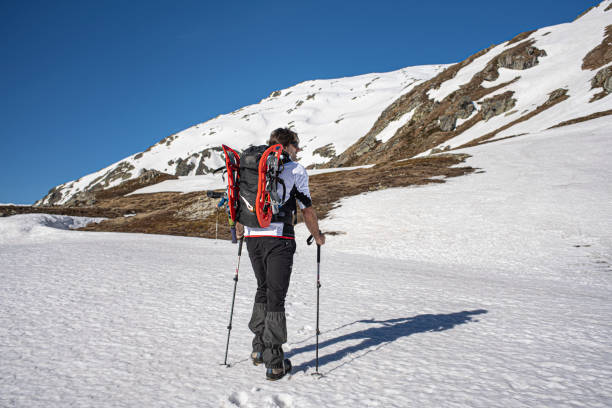 Solo Alpinist walking with Snowshoes Hiker snowshoeing on mountain lepontine alps stock pictures, royalty-free photos & images