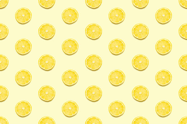 istock Lemon slices seamless pattern on pastel yellow background Minimal summer concept. 1155026114