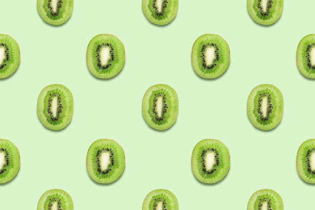Kiwi slices tropical seamless pattern on green background Minimal summer concept.