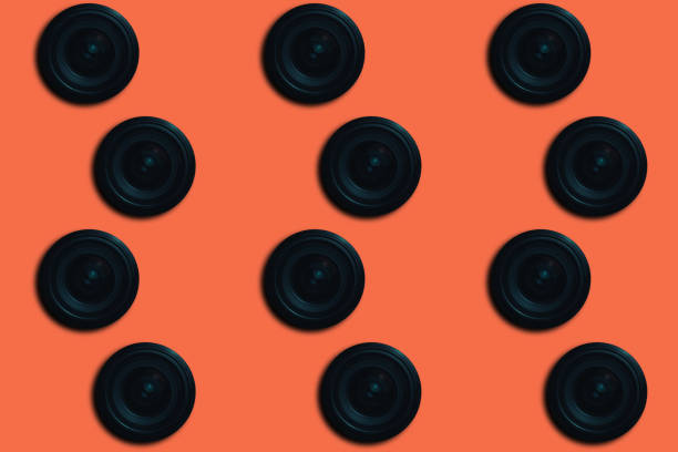 istock Black Camera Lens on a beautiful  coral orange background. 1155026624