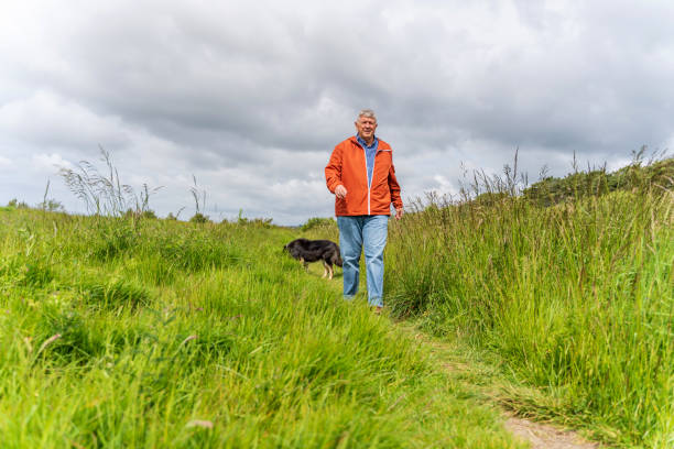 istock Active senior man and dog in countryside 1155026808