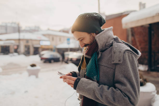 Young man on a winter day using smart phone