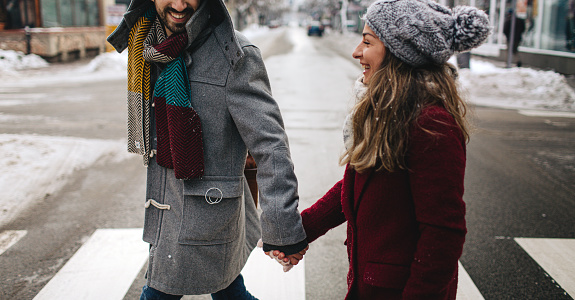 Beautiful couple having a winter walk in their city