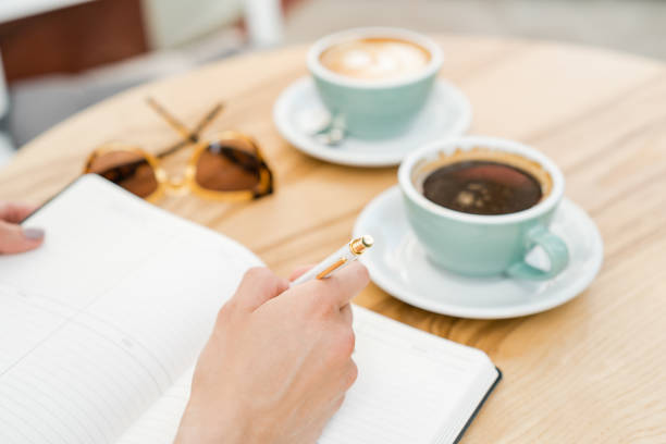istock Overhead view of a female blogger writing in her diary 1155034901