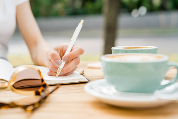 istock Businesswoman writing in her diary 1155034922