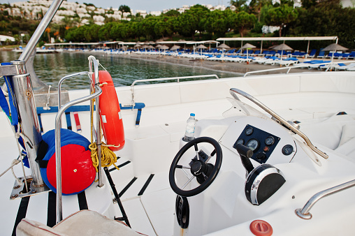 Yacht steering wheel motor boat on a calm blue sea of Bodrum, Turkey.