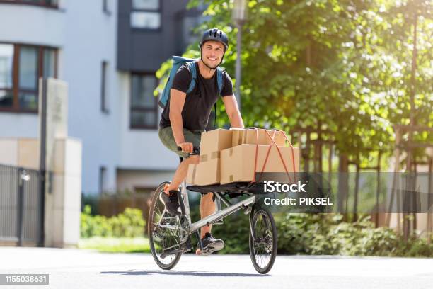 Bike Courier Making A Delivery Stock Photo - Download Image Now - Cargo Bike, Delivering, Delivery Person