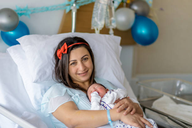 istock sleeping baby in mother's lap 1155041267