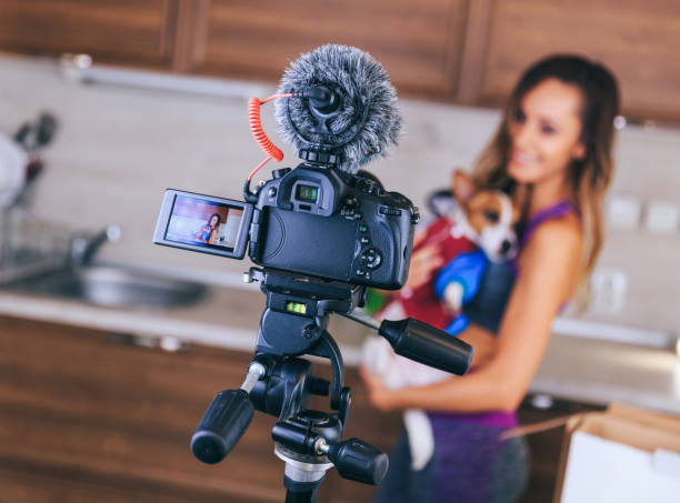 Female vlogger holding a dog