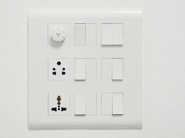 twelve electrical white switches, two sockets and a dimmer on a white wall - number 12 audio imagens e fotografias de stock