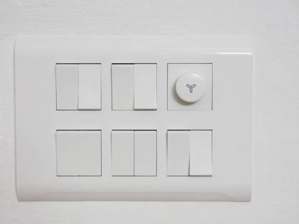 istock Ten white switches and a dimmer on a white wall 1155041937